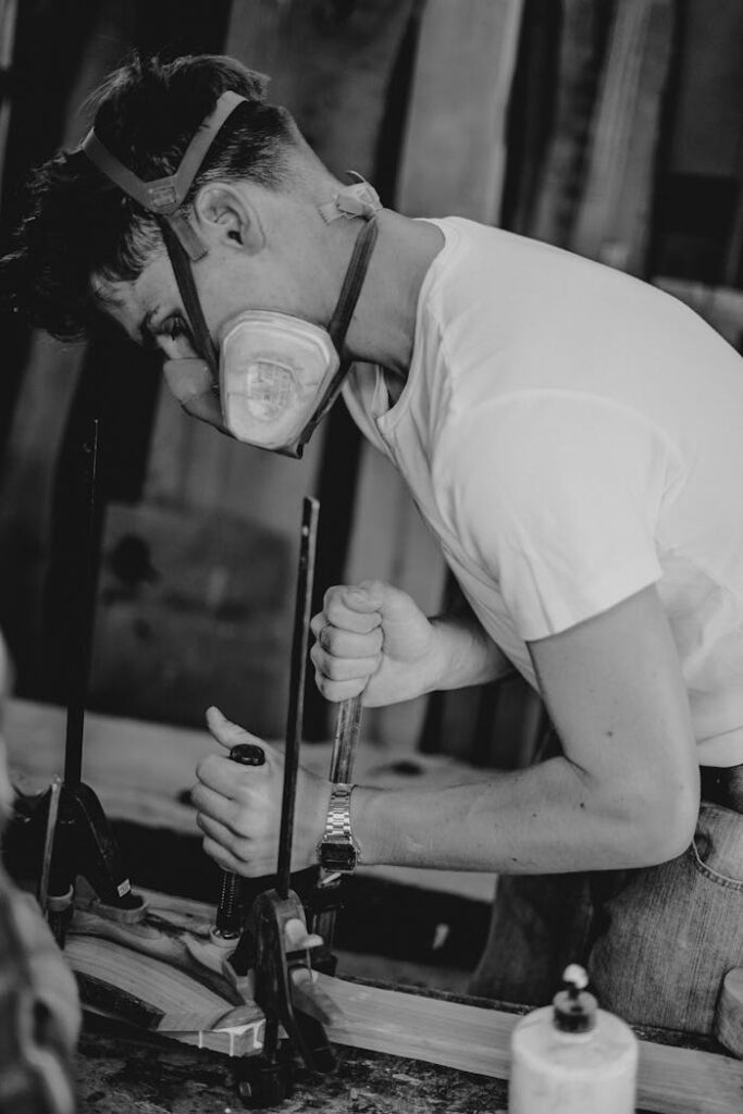 zipwp-image-5059642 Man Working in a Garage in Black and White